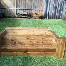 wooden retaining wall and lawn care